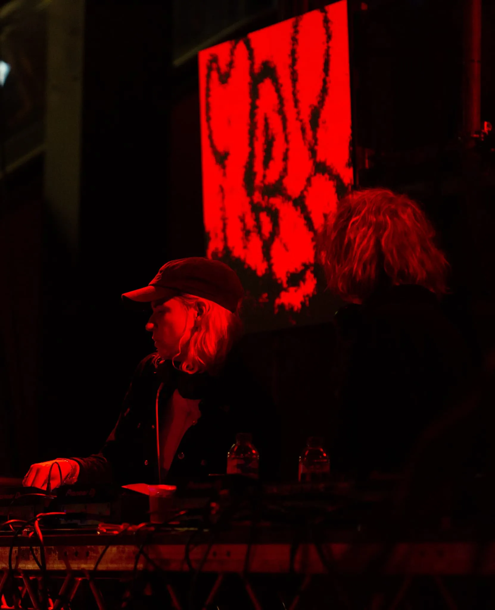 DJ and producer daniel avery looks at the visuals on LED panel during his b2b with HAAi.