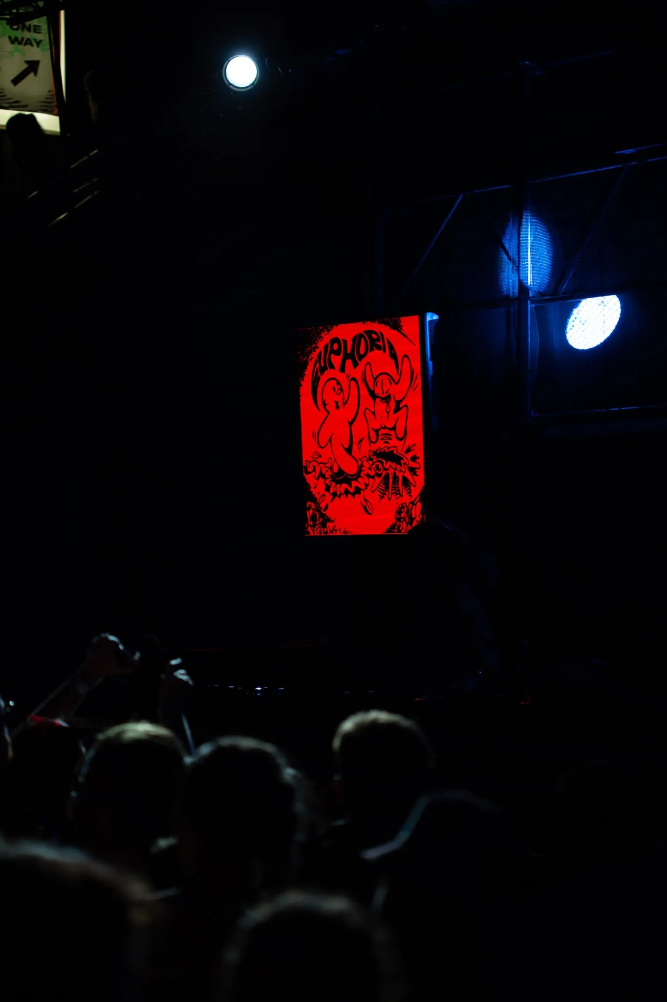 LED Panel attached to scaffolding shows euphoria graphic with contains words europhia above two rounded characters jumping from the ground looking like they are having euphoric time