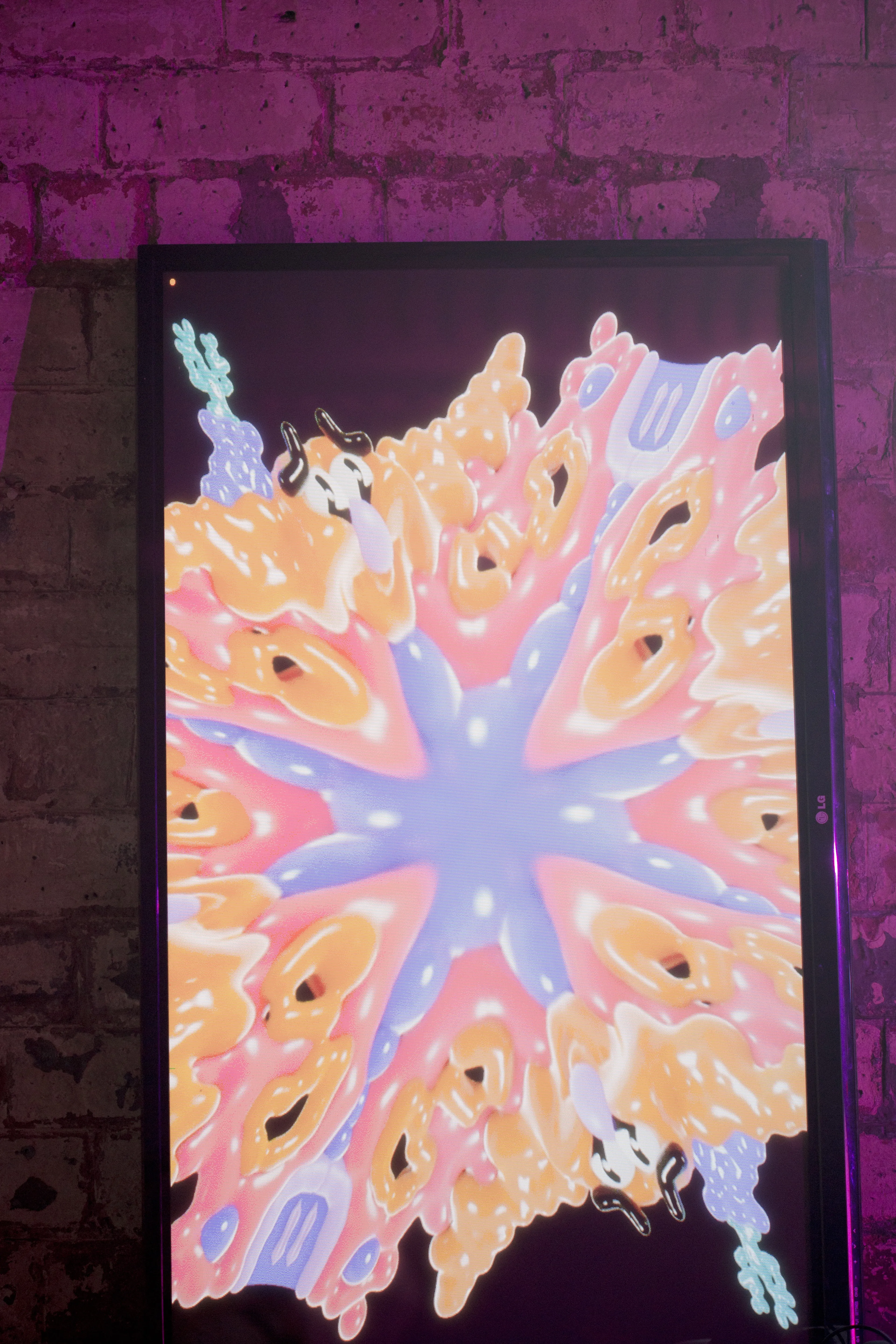 A TV shows a splatter of 3D colourful GUTS