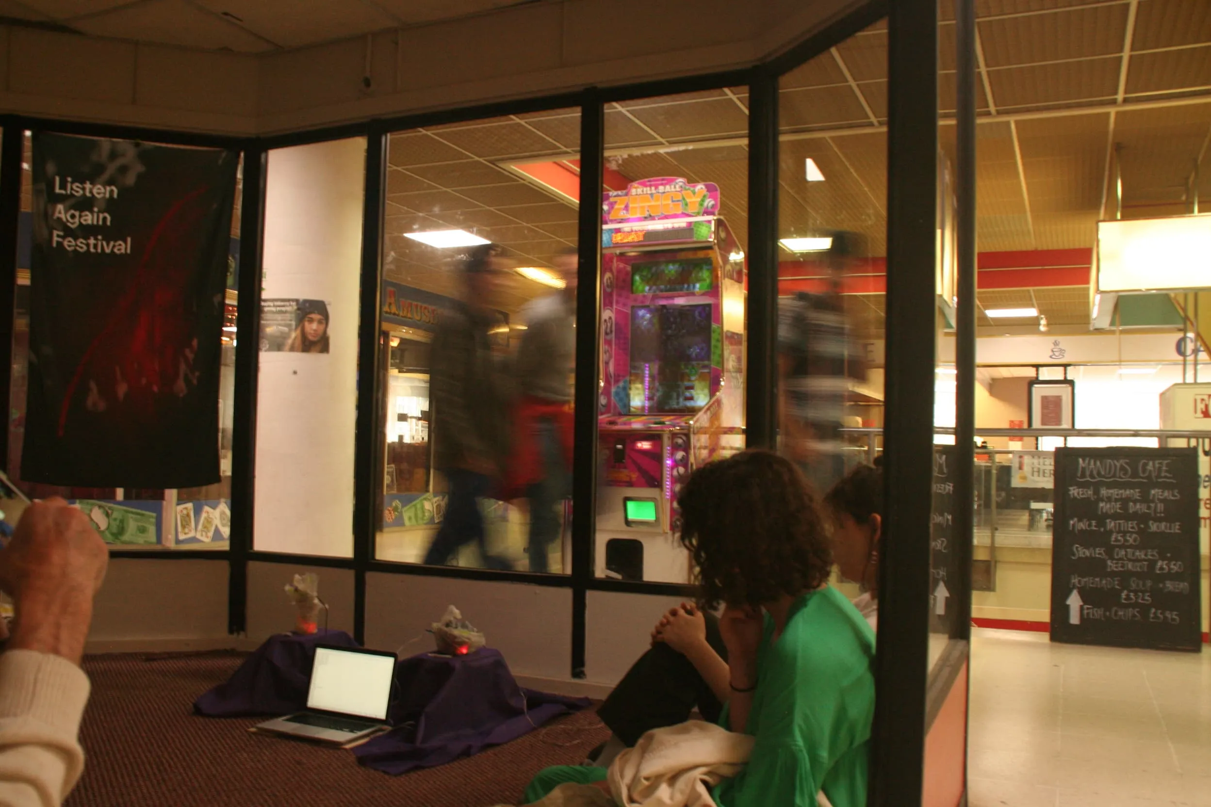 Installation of two arduinos with laptop in the middle in a small windowed space inside aberdeen market.