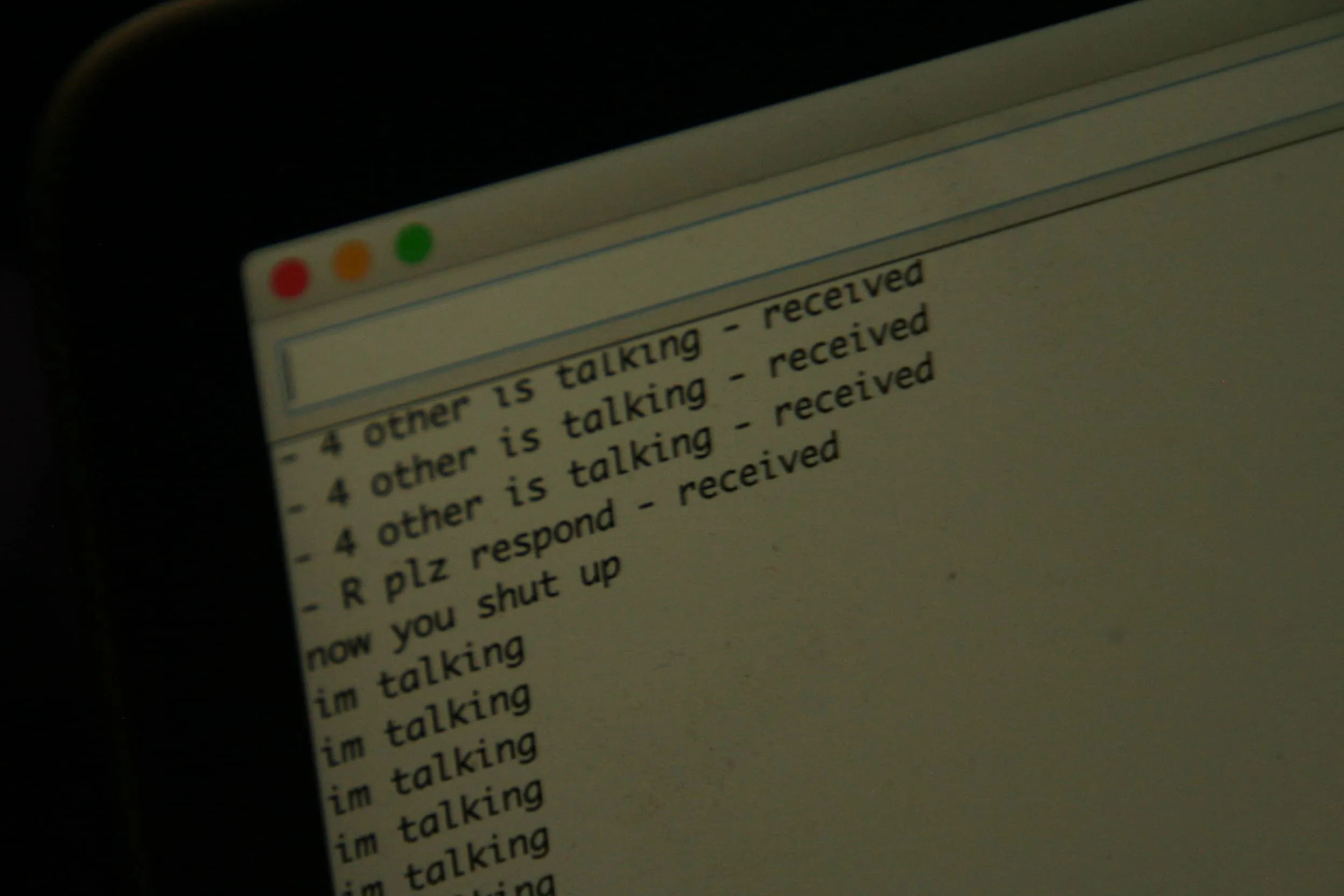 closeup of laptop screen showing the words '4 other is talking - recieved', 'now you shut up', and 'im talking'